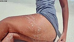 Sexy blonde rubs herself by sea with sandy hot ass