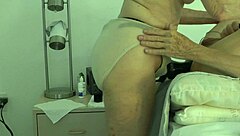 wife takes control, pegging her submissive husband in a domination session at home