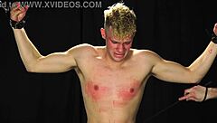 pretty blonde twink bound and whipped in dark bdsm dungeon