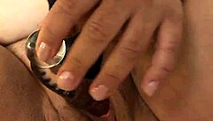 Voluptuous woman pleasures herself with toy