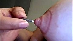 Detailed View Of Nipples Pierced With Needles In Fetish Scene