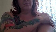 applying lotion to mature boobs