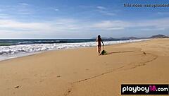 Inked brunette in bikini undresses on public beach