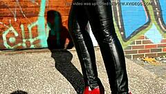 Outdoor blonde model poses in black leather attire
