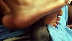 wife gives footjob to husband at home