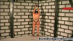 Busty brunette slave bound and tits squeezed by master