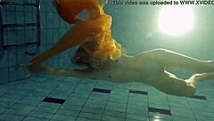 Nastya undresses and flaunts her sexy bare body in the swimming pool