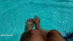 Young man's solo pool play with foot fetish twist
