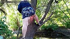 A horny mature woman pleasures herself outdoors with her legs and hands