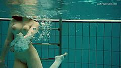 Dasha goes for a swim in the nude at the public beach