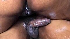 African American woman with a large buttocks mounts a black penis