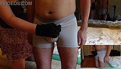 Femdom teases cock with handjob and slaps over pants.