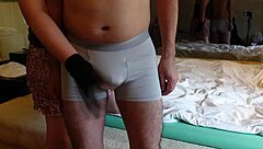 Femdom teases cock with handjob and slaps over pants.