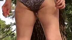 Playful girl enjoys solo pleasure outdoors