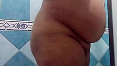 Pregnant Mexican Filipina woman showers after beach in voyeur video