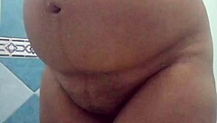 Pregnant Mexican Filipina woman showers after beach in voyeur video