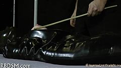 a submissive gets bound in intense bondage sadomasochism play with tight restraints