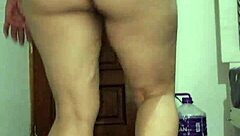 mature woman doing squats in tight leggings